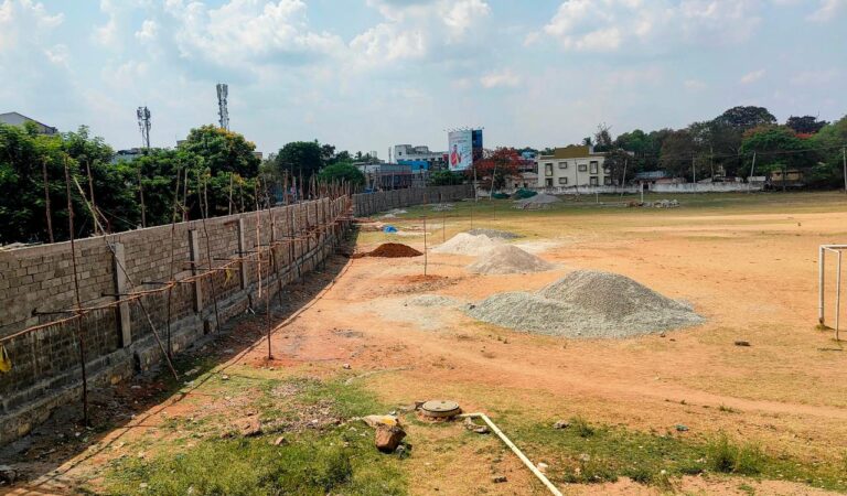 Trimulgherry football ground enclosed with high-rise wall amid corridor works